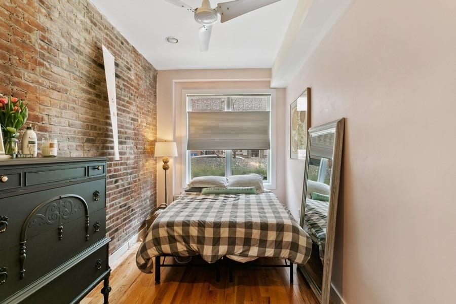 412 Monroe Street, Unit 2 Hoboken, NJ 07030 - Photo 7 of 16 a bedroom with a bed and wooden floor