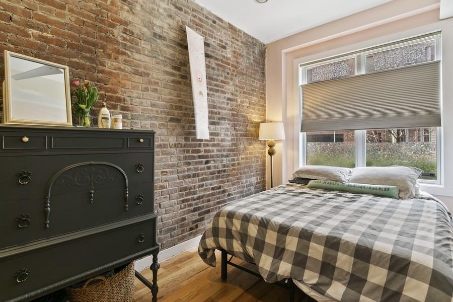 412 Monroe Street, Unit 2 Hoboken, NJ 07030 - Photo 8 of 16 a bedroom with a bed and a large window