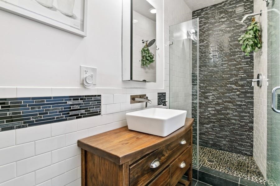 412 Monroe Street, Unit 2 Hoboken, NJ 07030 - Photo 10 of 16 a bathroom with a shower curtain and a sink