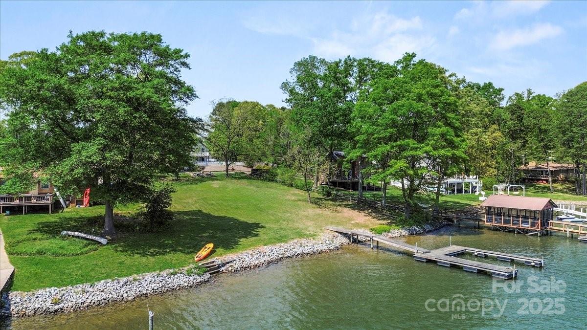 13 Normandy Road Denver, NC 28037 - Photo 9 of 14 a view of a lake with a yard and large trees
