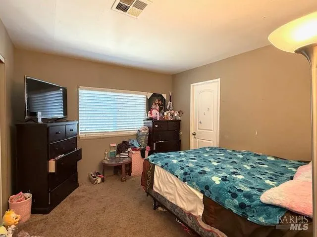 a bedroom with a bed and a television