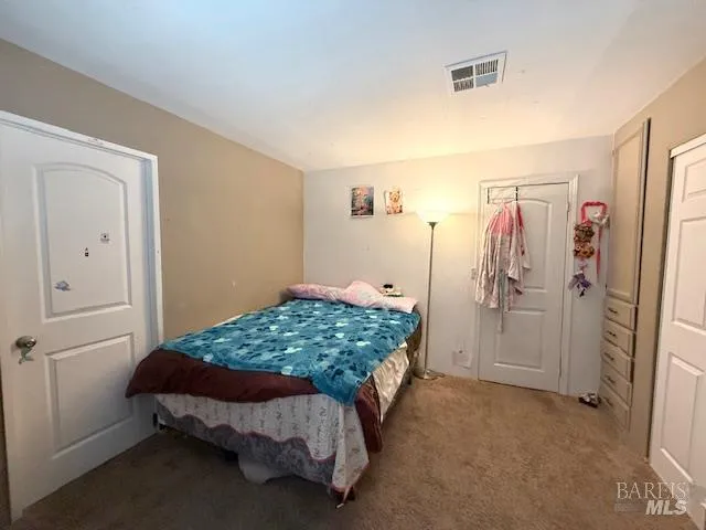 a bedroom with a bed and a cabinet