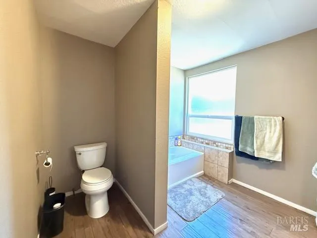 a bathroom with a toilet sink and tub