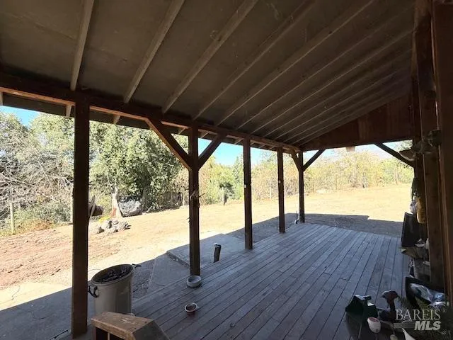 a view of porch with wooden floor