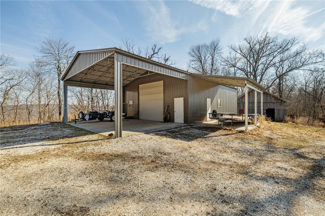 10557 North Devils Den Road Winslow, AR 72959 - Photo 36 of 60 View of parking featuring an outbuilding and a detached garage