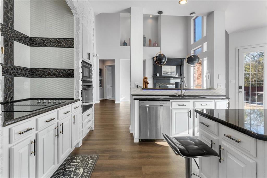8306 Sawgrass Lane Rowlett, TX 75089 - Photo 13 of 35 a kitchen with stainless steel appliances granite countertop a stove and a sink