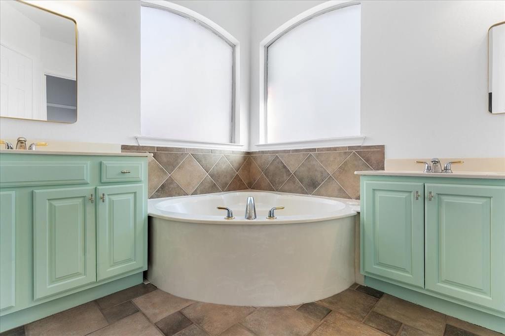 8306 Sawgrass Lane Rowlett, TX 75089 - Photo 20 of 35 a white bath tub sitting in a bathroom