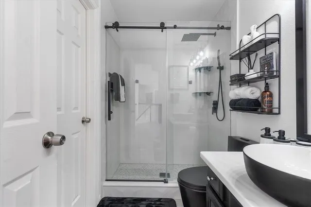 a bathroom with a sink toilet and shower