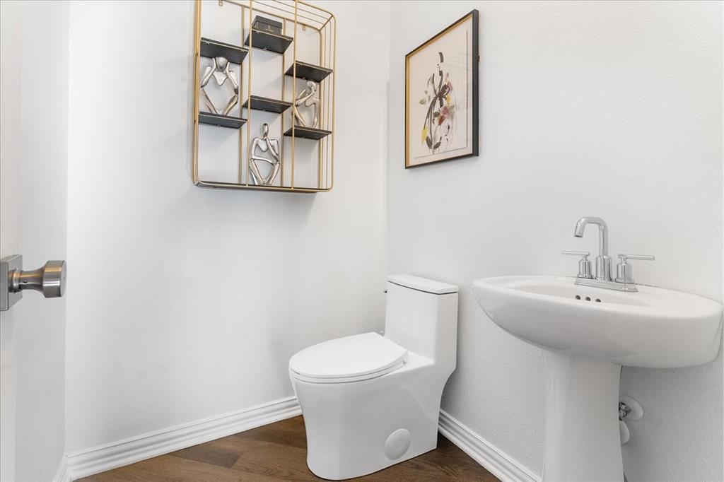 8306 Sawgrass Lane Rowlett, TX 75089 - Photo 25 of 35 a bathroom with a toilet and a sink