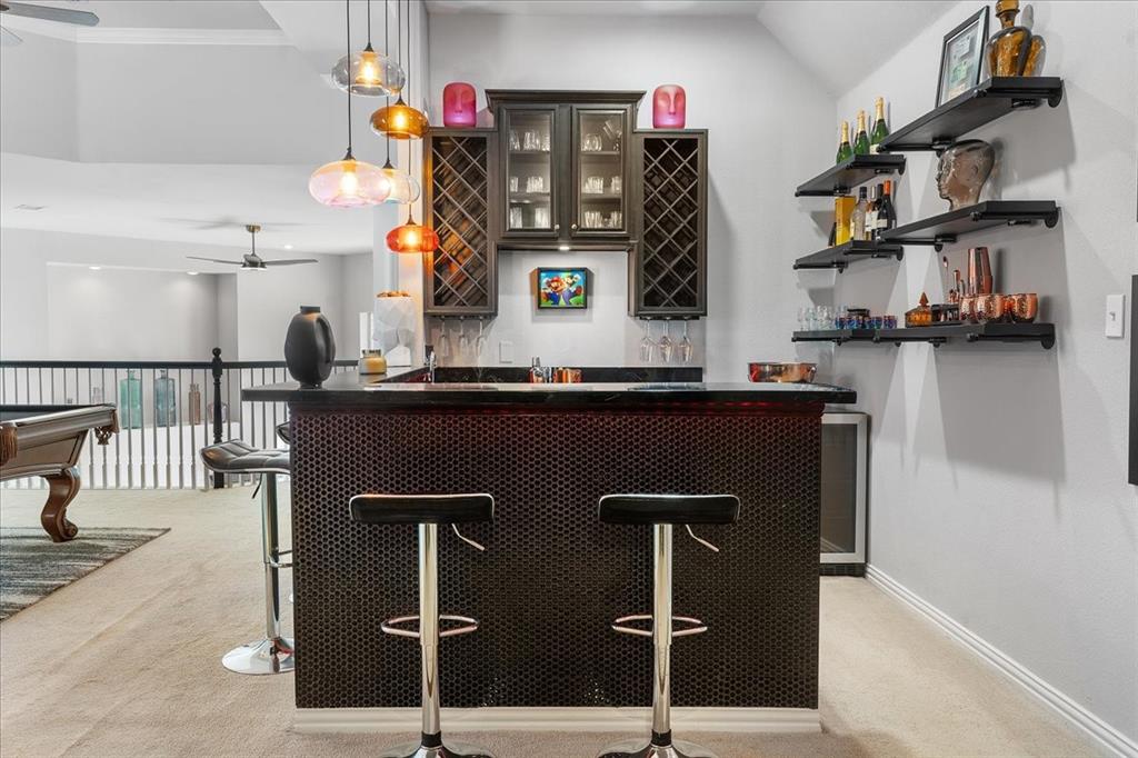 8306 Sawgrass Lane Rowlett, TX 75089 - Photo 27 of 35 a kitchen with stainless steel appliances granite countertop a sink and a refrigerator