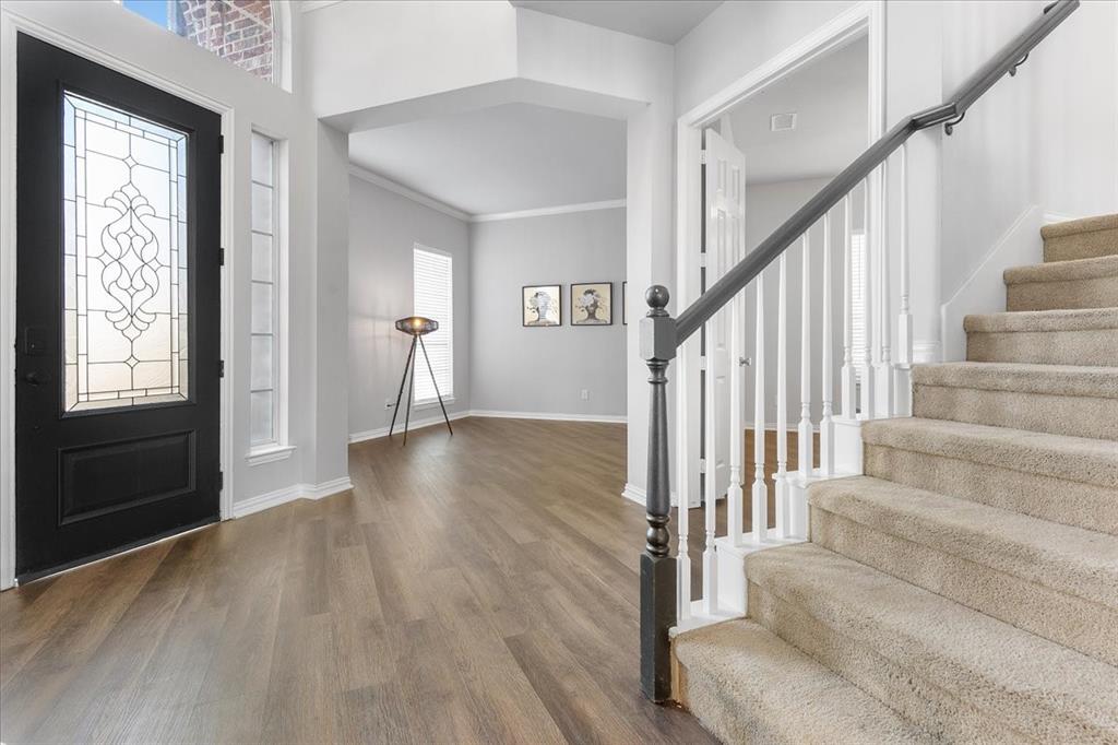 8306 Sawgrass Lane Rowlett, TX 75089 - Photo 3 of 35 a view of entryway and hall with wooden floor