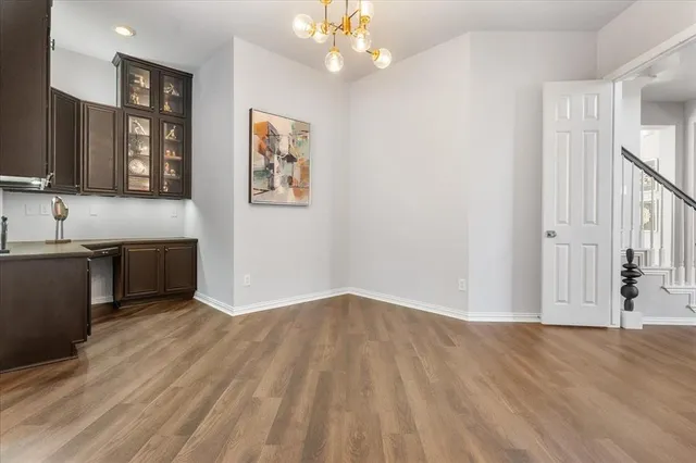 a view of a kitchen with wooden floor and a sink