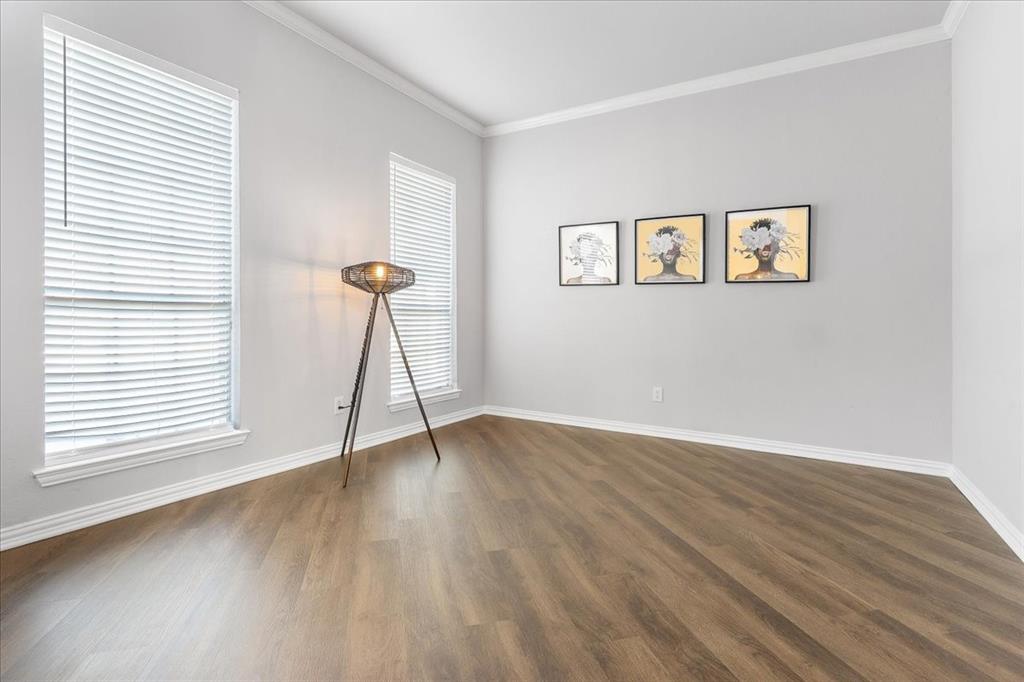 8306 Sawgrass Lane Rowlett, TX 75089 - Photo 5 of 35 a view of an empty room with wooden floor and a window