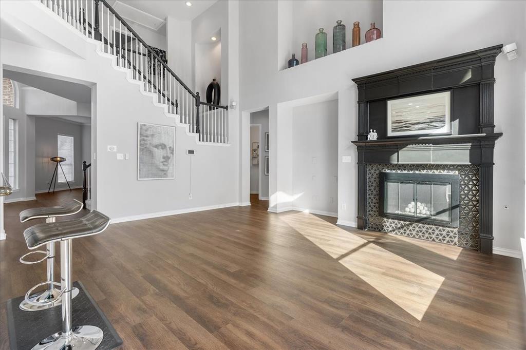 8306 Sawgrass Lane Rowlett, TX 75089 - Photo 6 of 35 a view of an empty room with wooden floor fireplace and a window