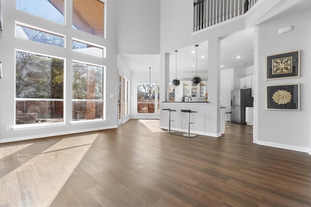 8306 Sawgrass Lane Rowlett, TX 75089 - Photo 7 of 35 a view of an empty room with a window and wooden floor