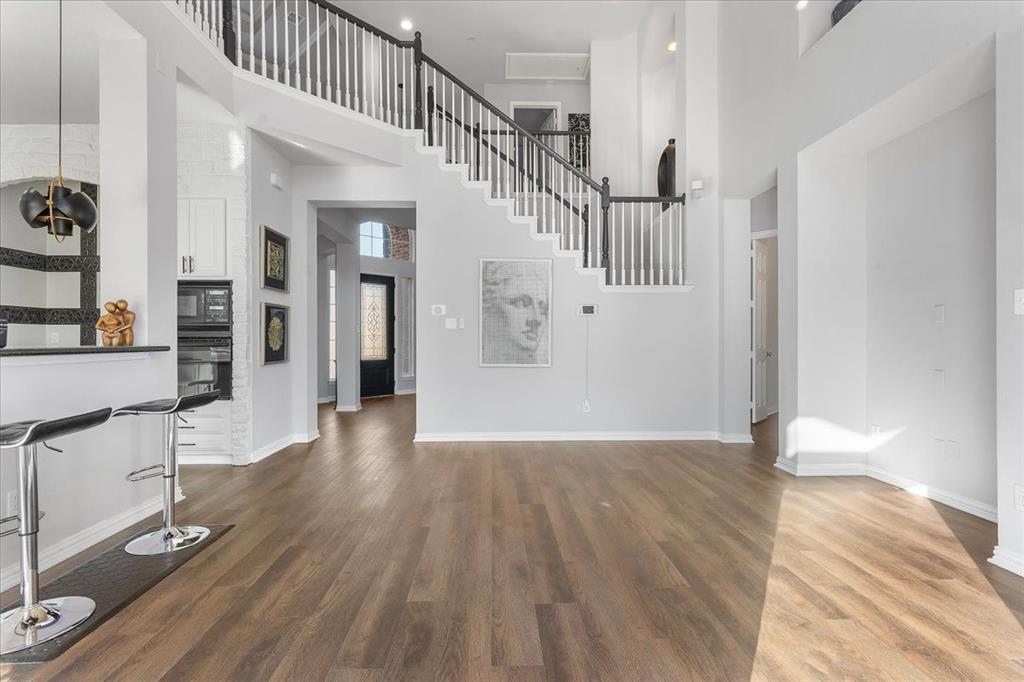 8306 Sawgrass Lane Rowlett, TX 75089 - Photo 8 of 35 a view of a hallway with wooden floor and staircase