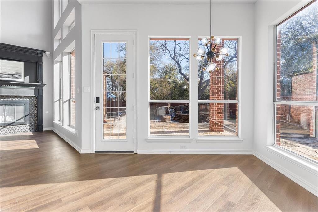 8306 Sawgrass Lane Rowlett, TX 75089 - Photo 10 of 35 a view of a room with wooden floor fireplace and windows
