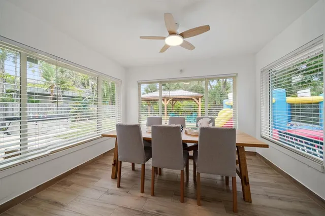 a view of a dining room with furniture window and wooden floor