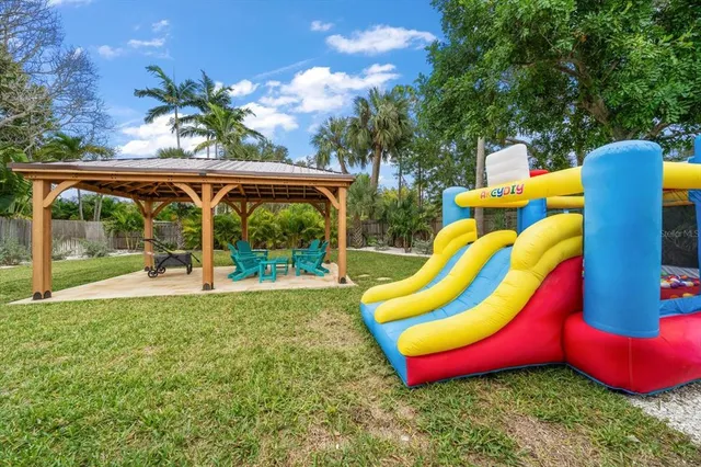 a view of a backyard with swimming pool and porch