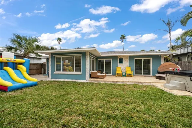 a view of a house with a backyard