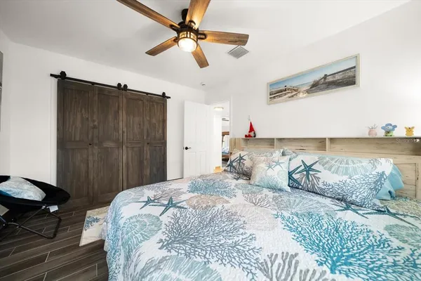 a bedroom with a bed and a chandelier