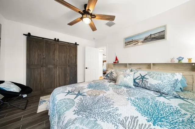 a bedroom with a bed and a chandelier