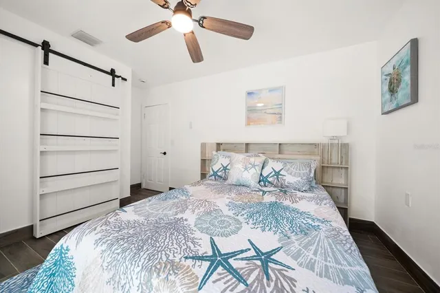 a bedroom with a bed and a chandelier