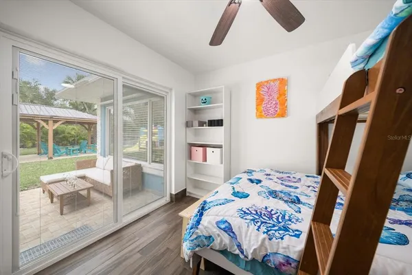 a bedroom with a bed and wooden floor