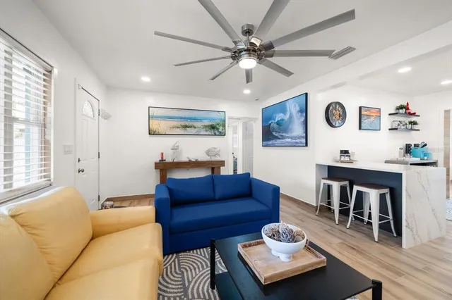 a living room with furniture and wooden floor
