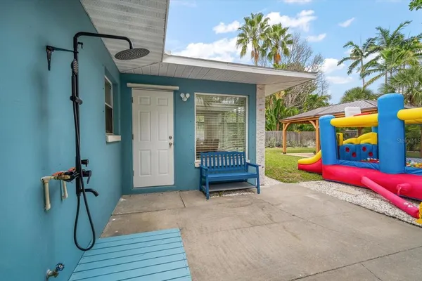 a view of a porch with furniture and a table
