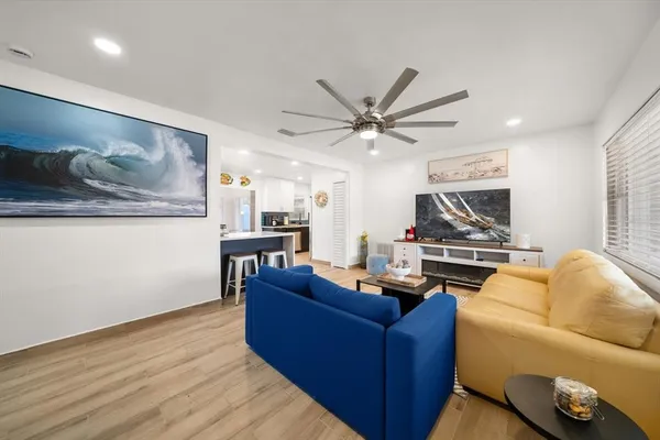 a living room with furniture and wooden floor