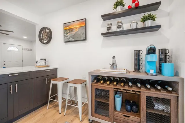 a kitchen with a stove and a table with a bookshelf