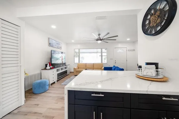 a living room with kitchen island furniture and a window