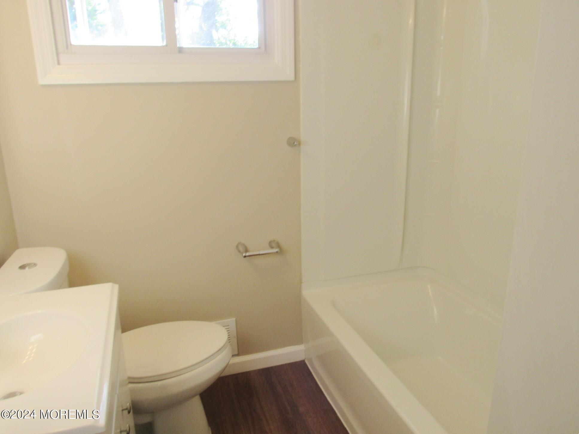 115 Solar Drive Brick, NJ 08724 - Photo 11 of 15 a white toilet sitting next to a bath tub