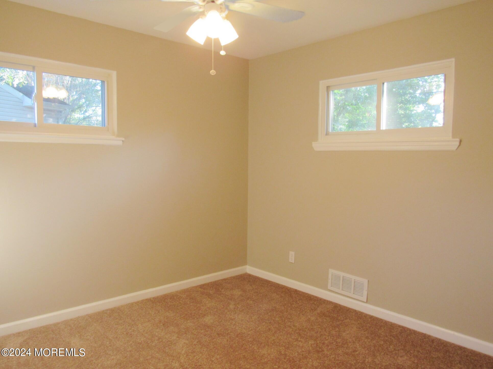115 Solar Drive Brick, NJ 08724 - Photo 14 of 15 an empty room with windows
