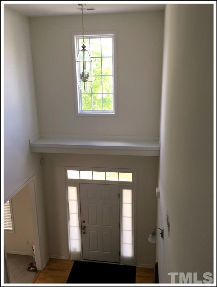 161 Longbay Street Garner, NC 27529 - Photo 5 of 9 The two-story foyer is filled with light from the sidelights on either side of the front door, and the window above.