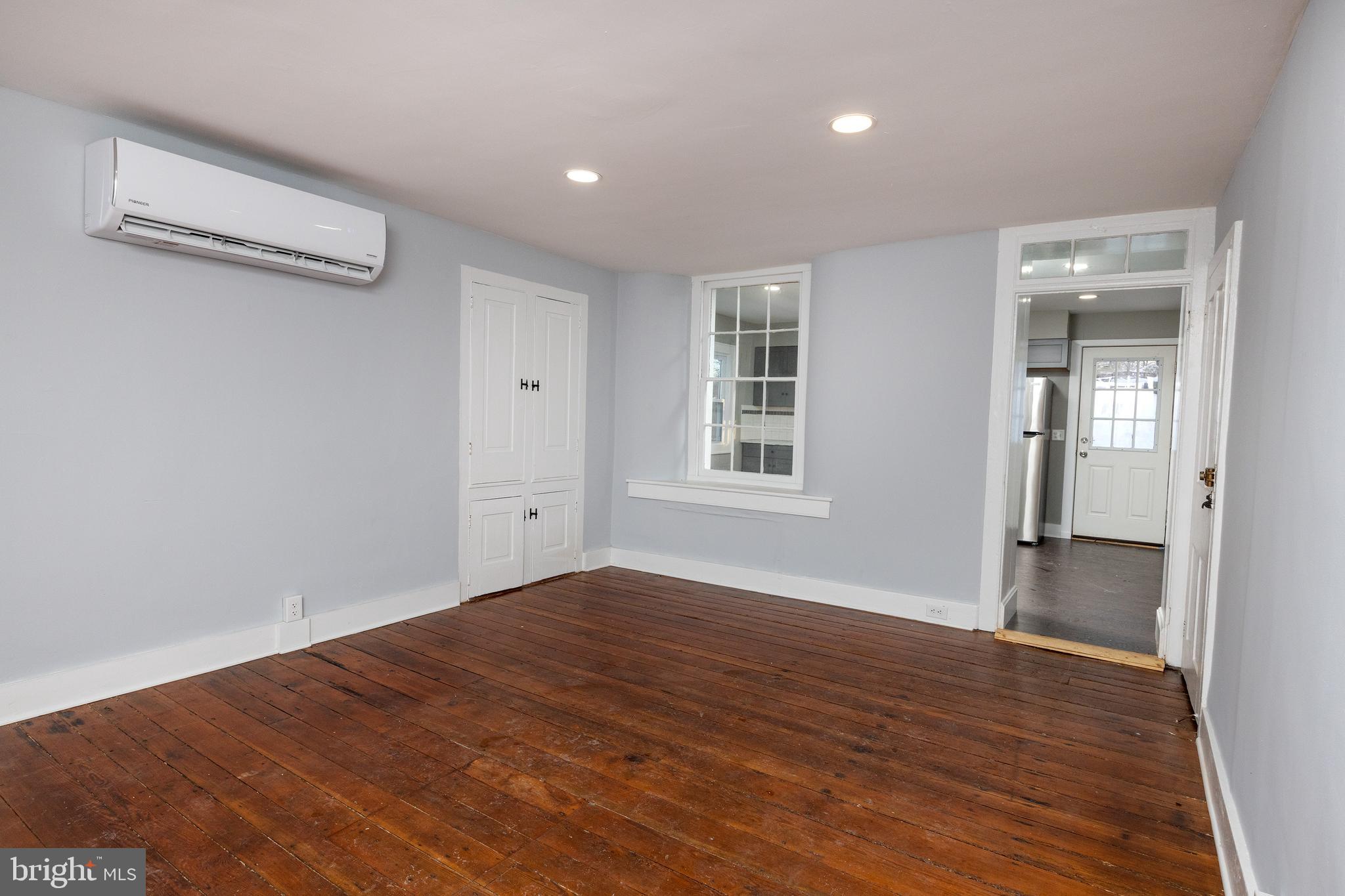 6192 Lower York Road, Unit B New Hope, PA 18938 - Photo 5 of 10 a view of an empty room with wooden floor and a window