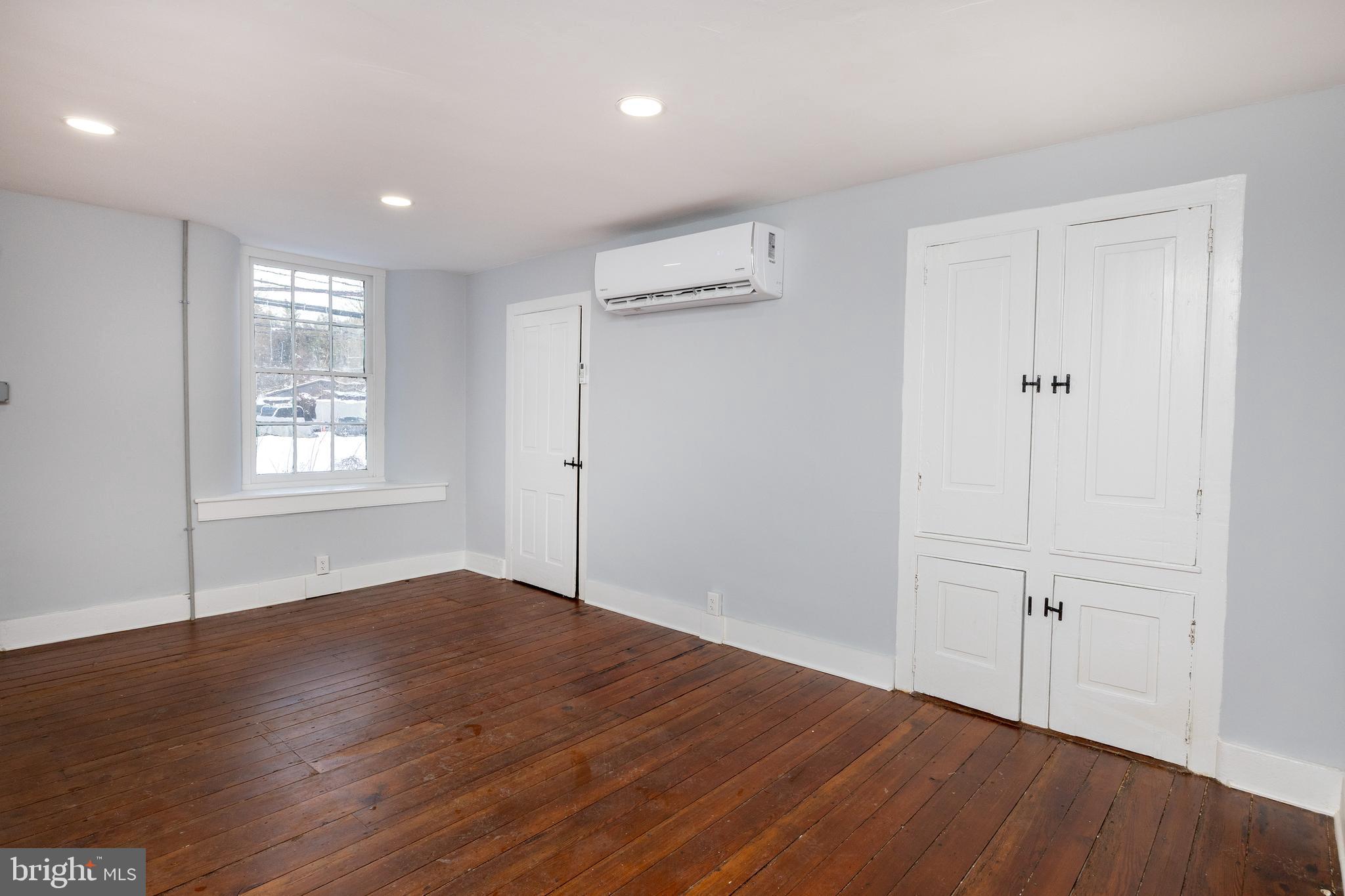 6192 Lower York Road, Unit B New Hope, PA 18938 - Photo 7 of 11 an empty room with wooden floor and windows