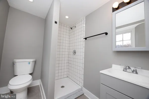 a bathroom with a toilet sink and a shower