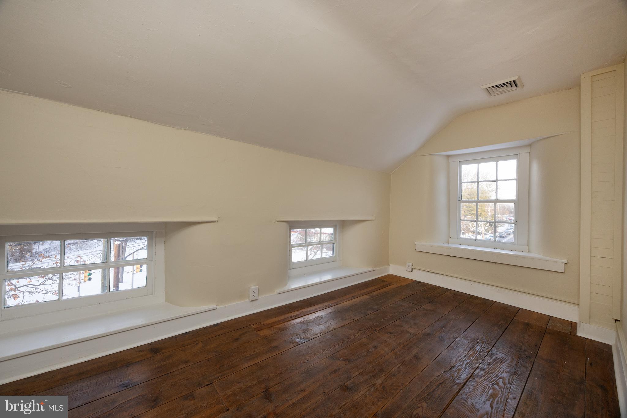 6192 Lower York Road, Unit B New Hope, PA 18938 - Photo 10 of 11 a view of an empty room with wooden floor and window