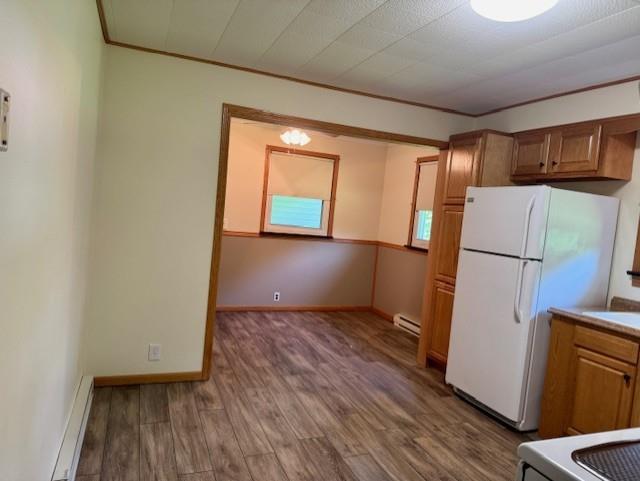 982 Smith Road New Castle, PA 16105 - Photo 2 of 29 an empty room with wooden floor and a refrigerator