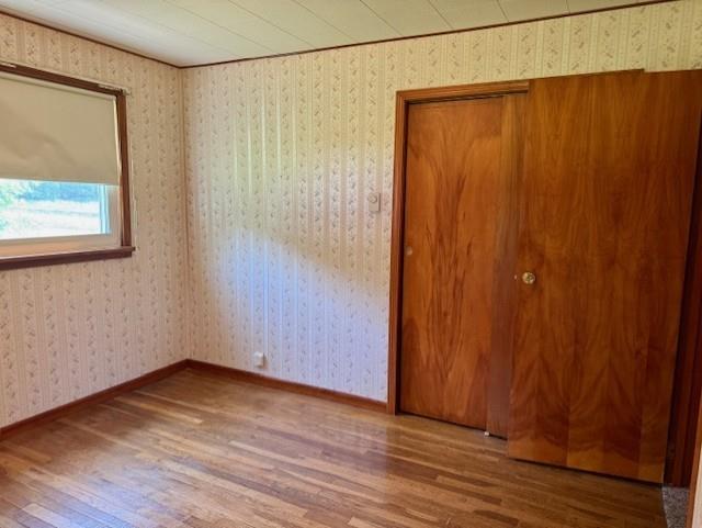 982 Smith Road New Castle, PA 16105 - Photo 9 of 29 a view of an empty room with wooden floor and a window