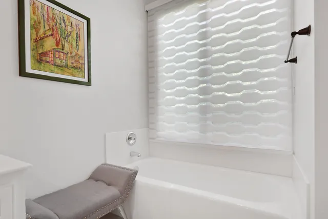 a view of a swimming pool with lawn chairs and a yard