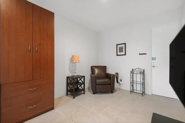 a view of a swimming pool and lounge chairs in back yard of the house