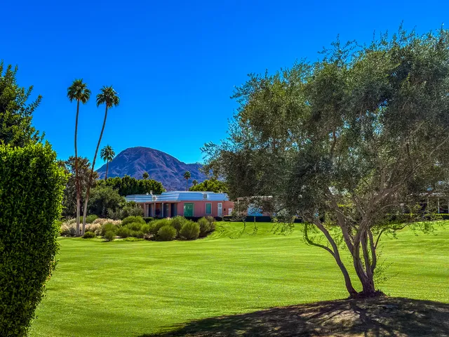 a view of yard with swimming pool and green space