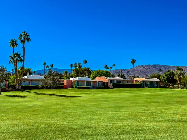 a view of an outdoor sitting space with mountains in the background