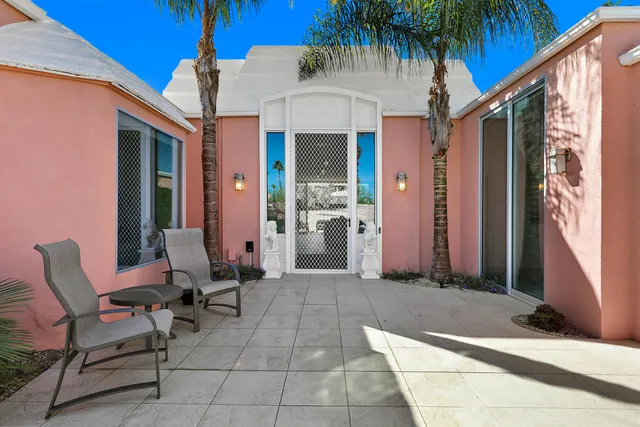 a view of a house with backyard and porch