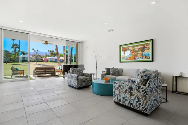 a living room with furniture and a baby crib