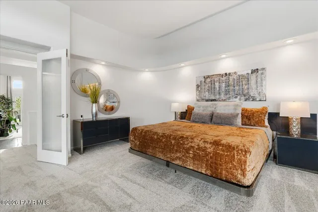 a bedroom with a bed and a dresser