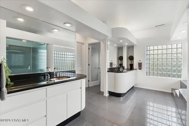 a large white kitchen with a large window